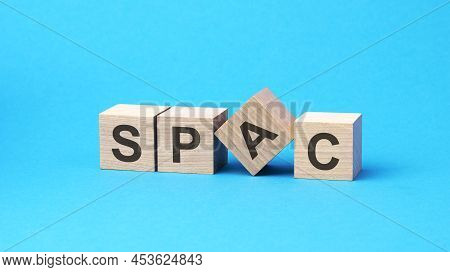 Spac - Word Is Written On Wooden Cubes Close-up. Bright Blue Background, Financial Business Concept,