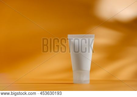 Cosmetic Container Mock Up. Blank Mosturizing Cream On Minimalistic Orange Background. Beauty Produc
