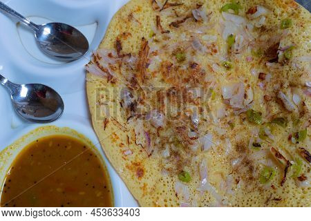 Uttapam Is Served With Chutney On White Plate, Indian Vegetable Dish.