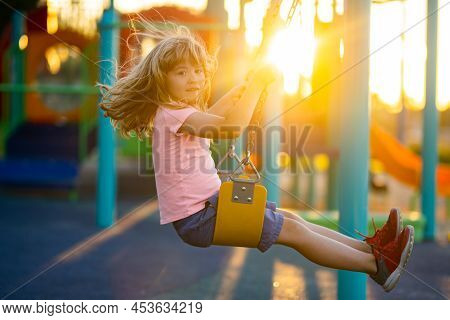 Child Boy Playing At Kids Playground. Active Little Child On Playground. Kids Play On School Or Kind