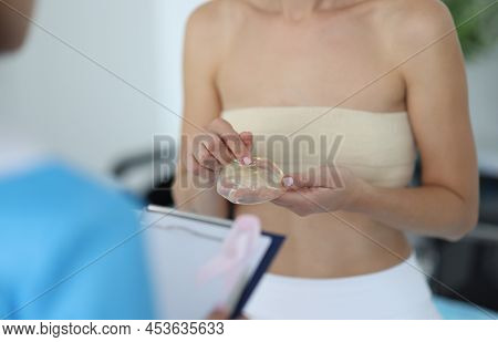 Close-up Of Woman Client Touch Silicone Implant, Breast Augmentation And Body Change. Breast Augment