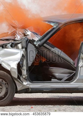 Thick Orange Smoke Coming Out Of The Crashed Car Completely Destroyed After The Traffic Accident On 