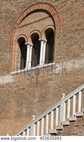 Three Windows Ogives In The Wall Of An Ancient Building And The Balustrade Of The Staircase