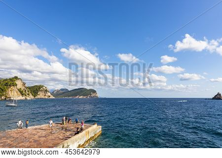 Petrovac, Montenegro, 29. August 2021: People At The Docks By The Sea In A Harbour In Town Petrovac,
