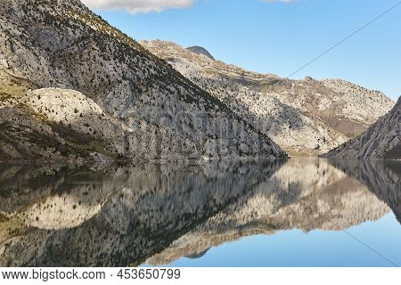 Picturesque Reservoir And Mountain Landscape In Riano. Mirror Effect. Spain