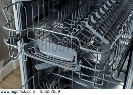 Open Dishwasher. Racks And Dishwasher Containers. Dishwashing