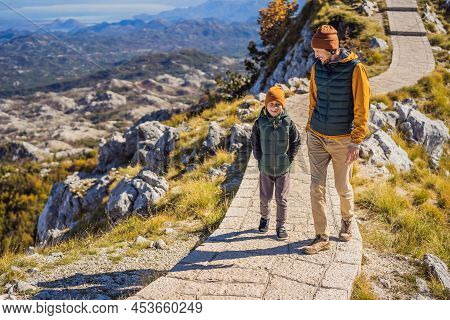 Dad And Son Travellers In Mountain Landscape At National Park Lovcen, Montenegro. Travel To Monteneg