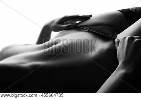 Close-up Of A Girl In Underwear Caressing Her Stomach With Her Hand While Lying On The Bed.