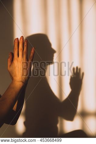 Shadow Or Silhouette Of A Woman Sitting With Her Hands Together Prayer Or Namaste Meditate In Sunset