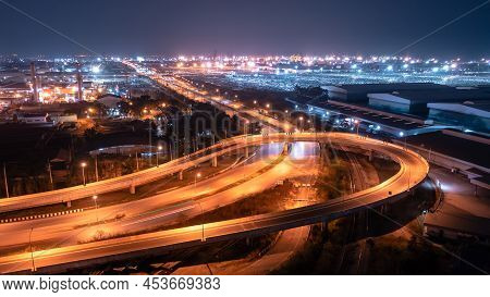 U Turn Bridge Traffic Transportation At Night Over Lighting And Factory Zone With Commercial Shippin