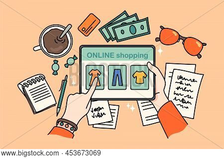 Top View Closeup Of Person Sit At Table Shopping Online On Tablet Gadget. Woman Buy Clothing On Inte