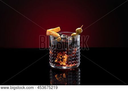 Vermouth Cocktail With Ice Isolated On Dark Red Background With Copy Space.