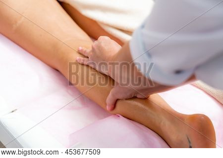 Facial Massage. A Woman Is Given A Massage In A Beauty Salon. Close-up.