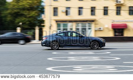 Car Bmw 430i Xdrive G22 Coupe On The Road In Motion. Fast Speed Drive On City Road. Side View Of Mov