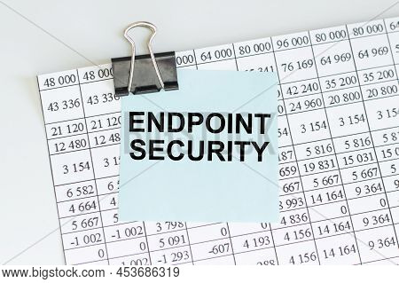 Endpoint Security Inscription On A Blue Card On The Clip To The Report Sheet On The Table