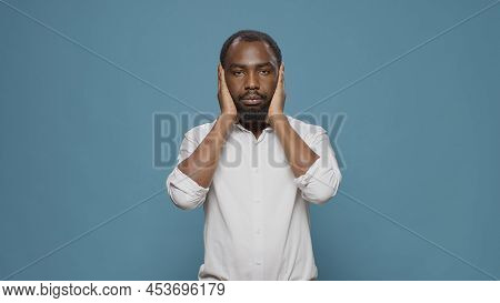 African American Man Doing Three Wise Monkeys Symbol, Covering Eyes, Mouth And Ears To Keep Secret A