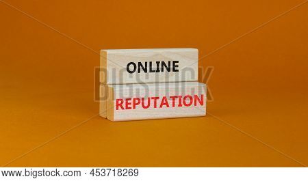 Online Reputation Symbol. Wooden Blocks With Concept Words Online Reputation On Beautiful Orange Bac