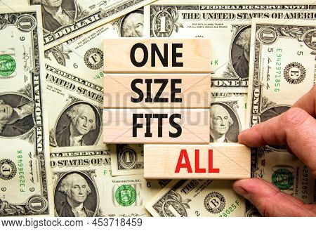 One Size Fits All Symbol. Concept Words One Size Fits All On Wooden Blocks. Businessman Hand. Beauti