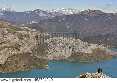 Picturesque Reservoir And Mountain Landscape In Riano. Hikkers. Spain