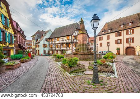 Ribeauville, France. Colorful Half-timbered Houses On Place De La Sinne Square