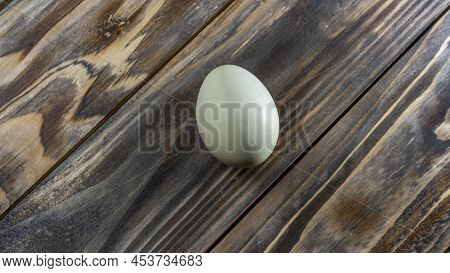 Araucana Egg On Wooden Background. Light Blue Egg From Araucana Chicken. Easter Festival Concepts. E