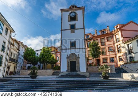Luanco, Asturias, Spain, May 30, 2021. Clock Tower And Houses In The City Of Luanco, In Asturias