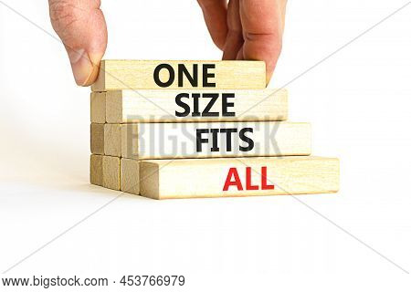 One Size Fits All Symbol. Concept Words One Size Fits All On Wooden Blocks. Businessman Hand. Beauti