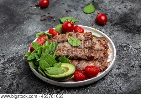 Chevapchichi Or Kofta Kebab, Bacon Wrapped Minced Meat With Spinach, Avocado And Cherry Tomato, Heal