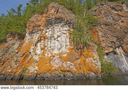 Lichen Colored Cliffs On A Remote Lakeshore On Ottertrack Lake In Quetico Provincial Park In Ontario