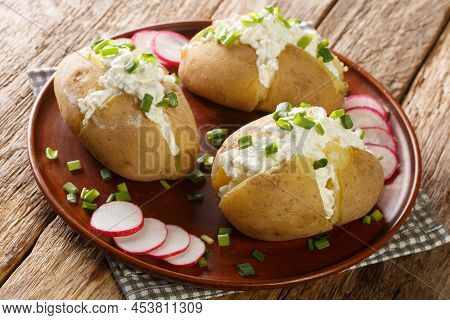 Homemade Potatoes Stuffed With Salted Cottage Cheese, Sour Cream And Green Onions Close-up In A Plat
