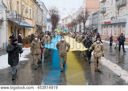 Zhytomyr, Ukraine - January 21, 2022: The Military And Children Carries The Longest Flag In Zhytomyr