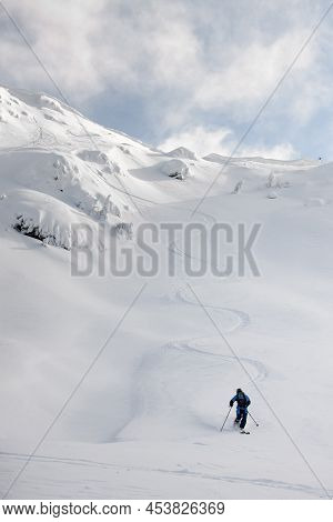 Athletic Snowboarder Ride Down The Untouched Powder Snow. Picturesque Snow Covered Mountain Scenery 