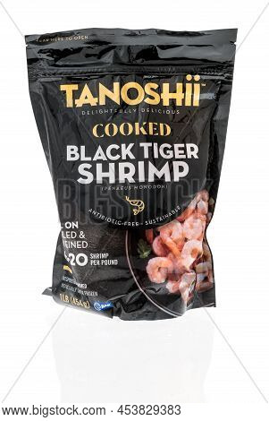 Winneconne, Wi -23 April 2022: A Package Of Tanoshii Cooked Black Tiger Shrimp On An Isolated Backgr