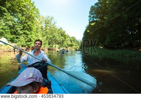 Family Kayak Trip. Father And Daughter, And Elderly Couple Senior And Seniora Rowing Boat On The Riv