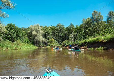 Family Kayak Trip. Man And Woman And Elderly Couple Senior And Seniora Rowing Boat On The River, A W