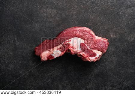 Raw Beef Meat. Rough Piece Of Meat On Bone For Roast Or Soup With Salt, Pepper, Thyme And Rosemary O