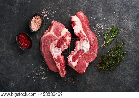 Raw Beef Meat. Rough Piece Of Meat On Bone For Roast Or Soup With Salt, Pepper, Thyme And Rosemary O