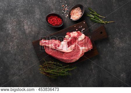 Raw Beef Meat. Rough Piece Of Meat On Bone For Roast Or Soup With Salt, Pepper, Thyme And Rosemary O