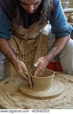 Amarante, Portugal - April 30: Potter Shaping A Piece Of Clay On A Low Wheel On April 30, 2022 In Am