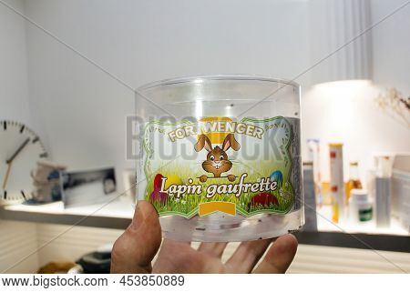 Paris, France - Apr 29, 2022: Male Hand Holding Empty Plastic Recipient With Fortwenger Lapin Gaufre