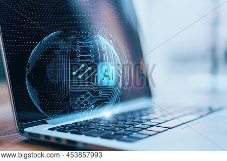 Close Up Of Laptop With Abstract Glowing Ai Sphere On Blurry Background. Artificial Intelligence And