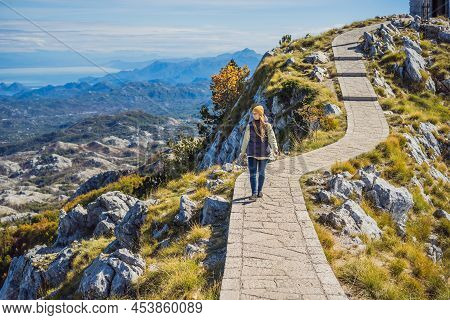 Woman Traveller In Mountain Landscape At National Park Lovcen, Montenegro. Travel To Montenegro Conc