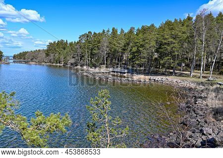Looking Out Over Lake Vattern And A Little Beach With A Jetty