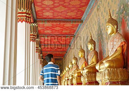 Visitor At The Cloister With Large Group Of Seated Buddha Images In Wat Arun Or The Temple Of Dawn, 