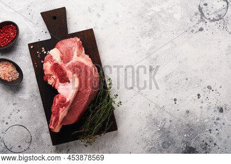 Raw Beef Meat. Rough Piece Of Meat On Bone For Roast Or Soup With Salt, Pepper, Thyme And Rosemary O