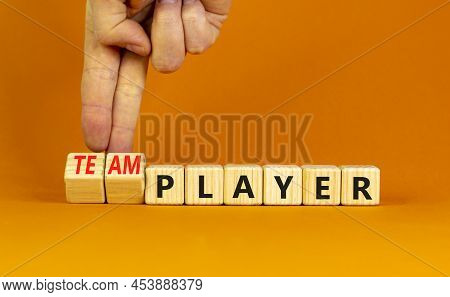 Player Or Teamplayer Symbol. Businessman Turns Wooden Cubes And Changes Concept Words Player To Team