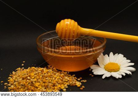 A Yellow Spoon Of Honey Dipped In A Jar Of Honey And Bee Bread Scattered On A Black Background Decor