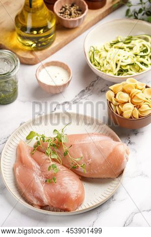 Fresh Ingredients For Preparing A Warm Salad On Marble Surface: Chicken Breasts, Heavy Cream, Zucchi