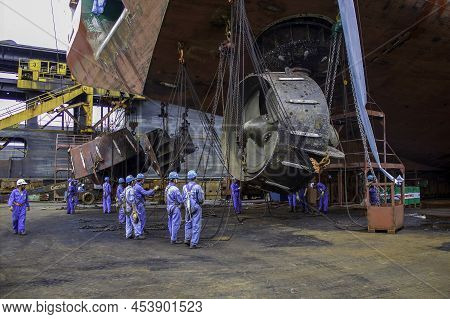Sembawang, Singapore - Mar 2 2013: Sembawang Ship Yard Workers Changing Stern Nozzle Azipod Thruster