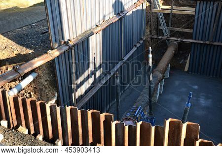 Repair Of Water Supply, Gas Connection In Deep Excavation. The Pipe Is Rusty And There Is A Main Wat